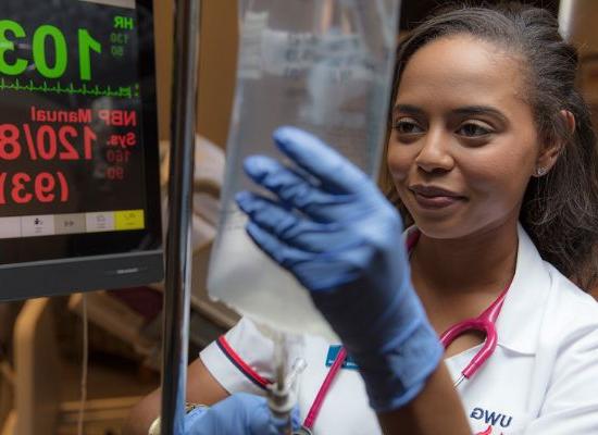 Student in the nursing program adjusting an IV