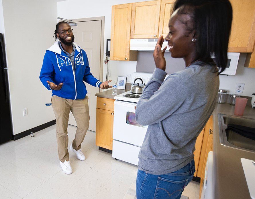 students talking in kitchen